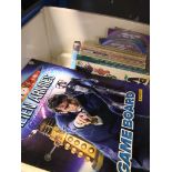 A box with a collection of Dr Who books, magazines and CDs.