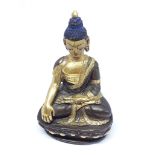 A miniature gilt bronze buddha, height 8cm.