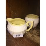 A cream Belleek milk jug and sugar bowl (appx 8cm high)