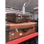 A large vintage suitcase and a small suitcase.