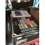 A box containing a few stamp albums and stamp magazines and stamp catalogues