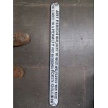 A vintage cast metal penalty notice sign