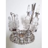 An Art Deco silver plated two bottle cruet, with the bottles having silver collars, along with other
