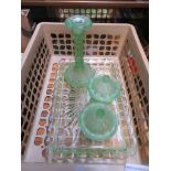 A green glass dressing table set comprising tray, two lidded trinket pots and a candlestick