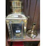 A brass ships oil lamp and a brass ships candlestick