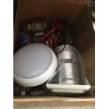 A box containing battery charger, pay as you go electric meter, expelair unit, 2 bulkhead lights,
