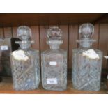 Pair of glass decanters with porcelain labels and another