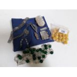 A mixed lot comprising beads, miniature note pad, purse, white metal etc.