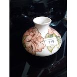 A Moorcroft pottery cream ground vase, height 10cm