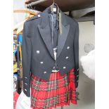 A dress kilt in Royal Stewart(?) tartan size 3322-34 waist, sporran, waistcoat and dress jacket