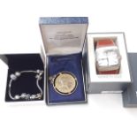 A Pandora bracelet, a Royal Mint gold plated coin, and a Kenneth Cole wristwatch in box.