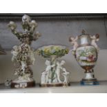 A collection of Moore porcelain comprising a cherub ornate candelabra, a centre piece and a vase and