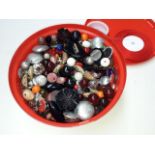 A tub of beads and elastic for jewellery making