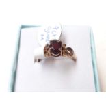 A hallmarked 9ct gold ring with garnet stone