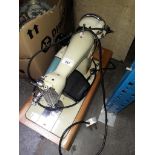 A Brother electric sewing machine with power cable, foot pedal and case