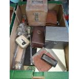 A cased research magnifier, a volt meter, a revolutions measuring device, and an assortment of
