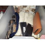 A box with wool scarves, pencils, phone cases, purse, etc.