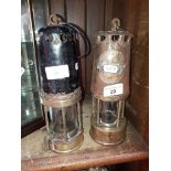 Two old miners lamps including 'The Protector Lamp & Lighting Co.',