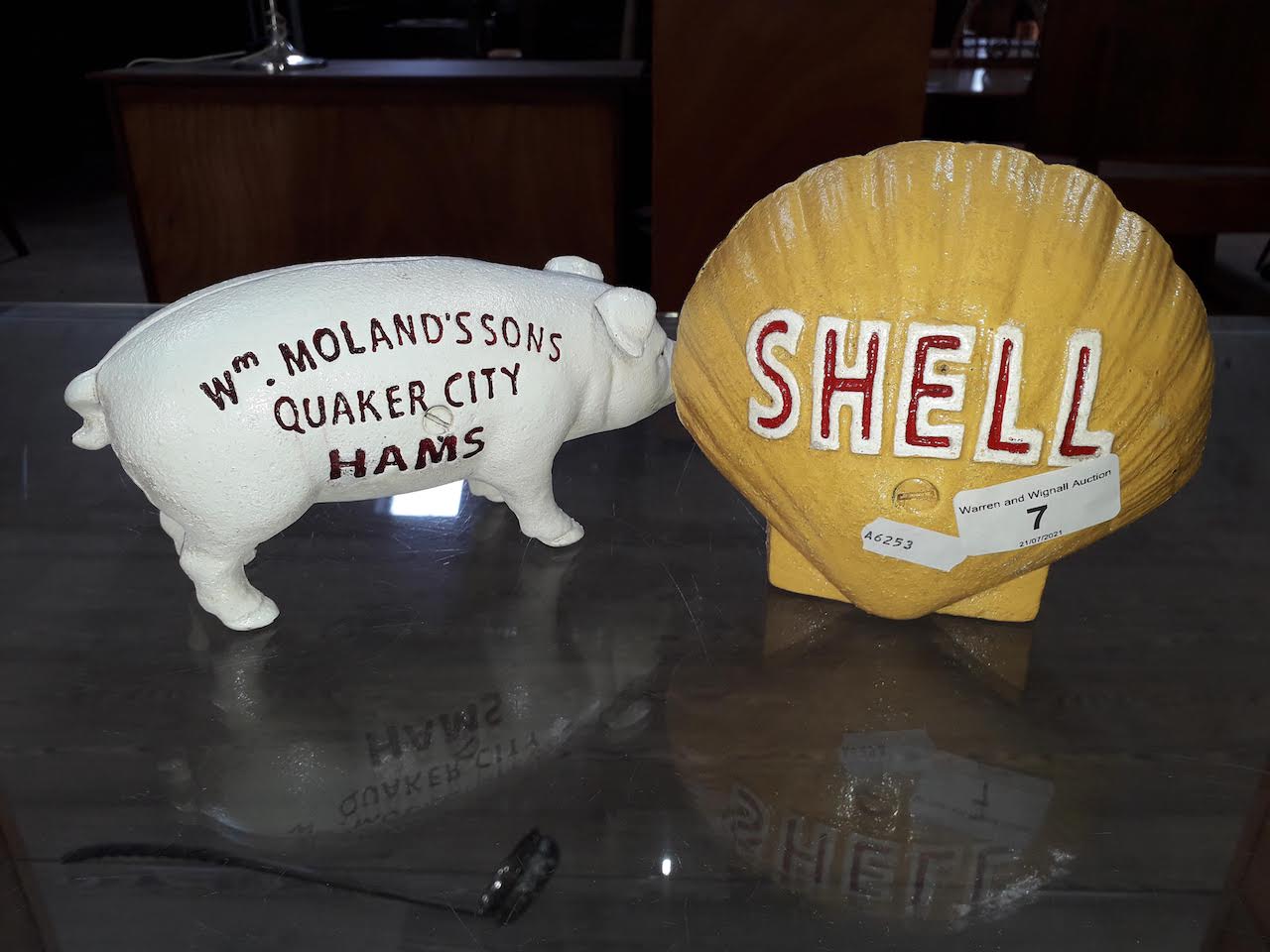 Two cast metal money boxed - one shaped as a Shell Oil symbol, and the other in the shape of a pig