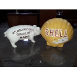 Two cast metal money boxed - one shaped as a Shell Oil symbol, and the other in the shape of a pig