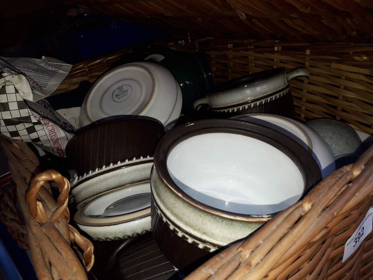A wicker basket of Denby ware