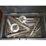A small metal box containing taps & dies