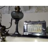 A french oil lamp, a brass light fitting and a 1920's perpetual calender