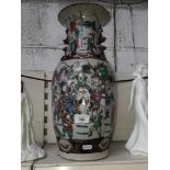 A late 19th century Chinese crackle glaze vase decorated in over enamels with figures and applied