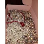 A box of perl necklaces and loose pearls