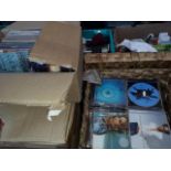 Two boxes of cds and a box of commemorative mugs