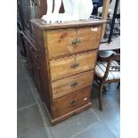 A rustic narrow chest of drawers.