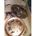 A box with copper wall plaques and a tray