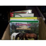 A box containing 12 books on horses and a box of 24 dvds on riding a pony
