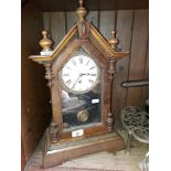 A wooden cased mantle clock with pendulum and key