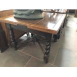 A 1920s oak drawer leaf table with twist legs.