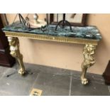 A reproduction gilded two legged console table with lion head carved legs and claw and ball feet and