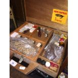 A wooden box of fly fishing equipment, feathers, hooks, swivels, etc.