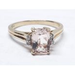 A hallmarked 9ct gold ring set with a central rectangular mixed cut pale peach/pink morganite, gross