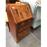 A reproduction yew wood bureau