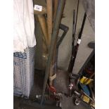 A bundle of garden tools, spade, fork, rake and a Moveit tool.