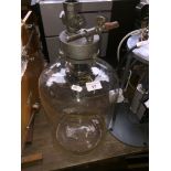 A vapour diffusion pump and a glass pressure vessel.