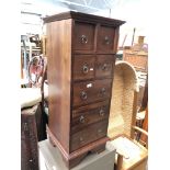 A tall hardwood bank of drawers