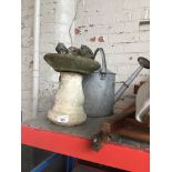 A small concrete bird bath, a concrete squirrel and a vintage watering can