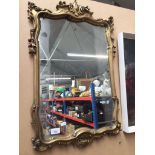 An ornate gilt framed mirror