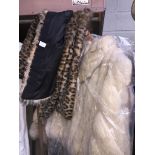 A fur jacket together with a faux fur jacket