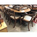 A mahogany Regency style extending dining table and eight chairs