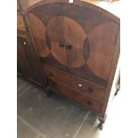 An Art Deco domed top cupboard