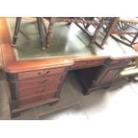 A reproduction mahogany partner's desk.