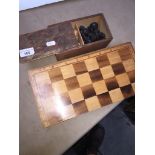A chess board and 2 sets of chess pieces.