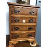 A reproduction yew wood chest of drawers.